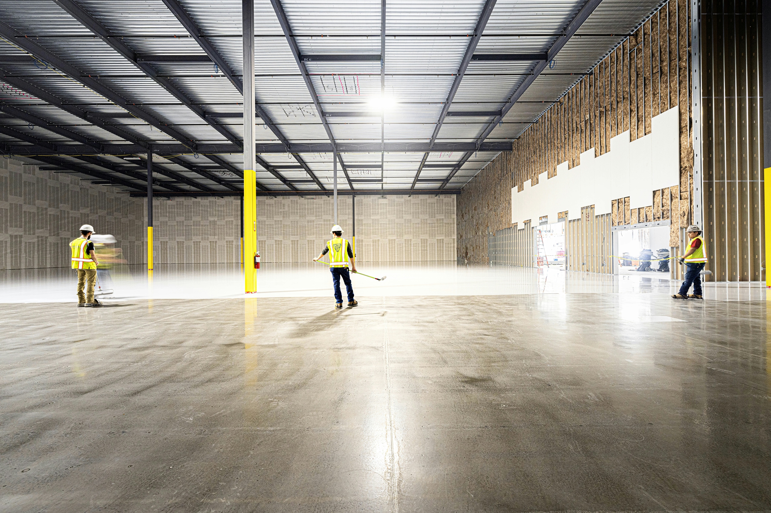 Workers polishing a commercial concrete floor