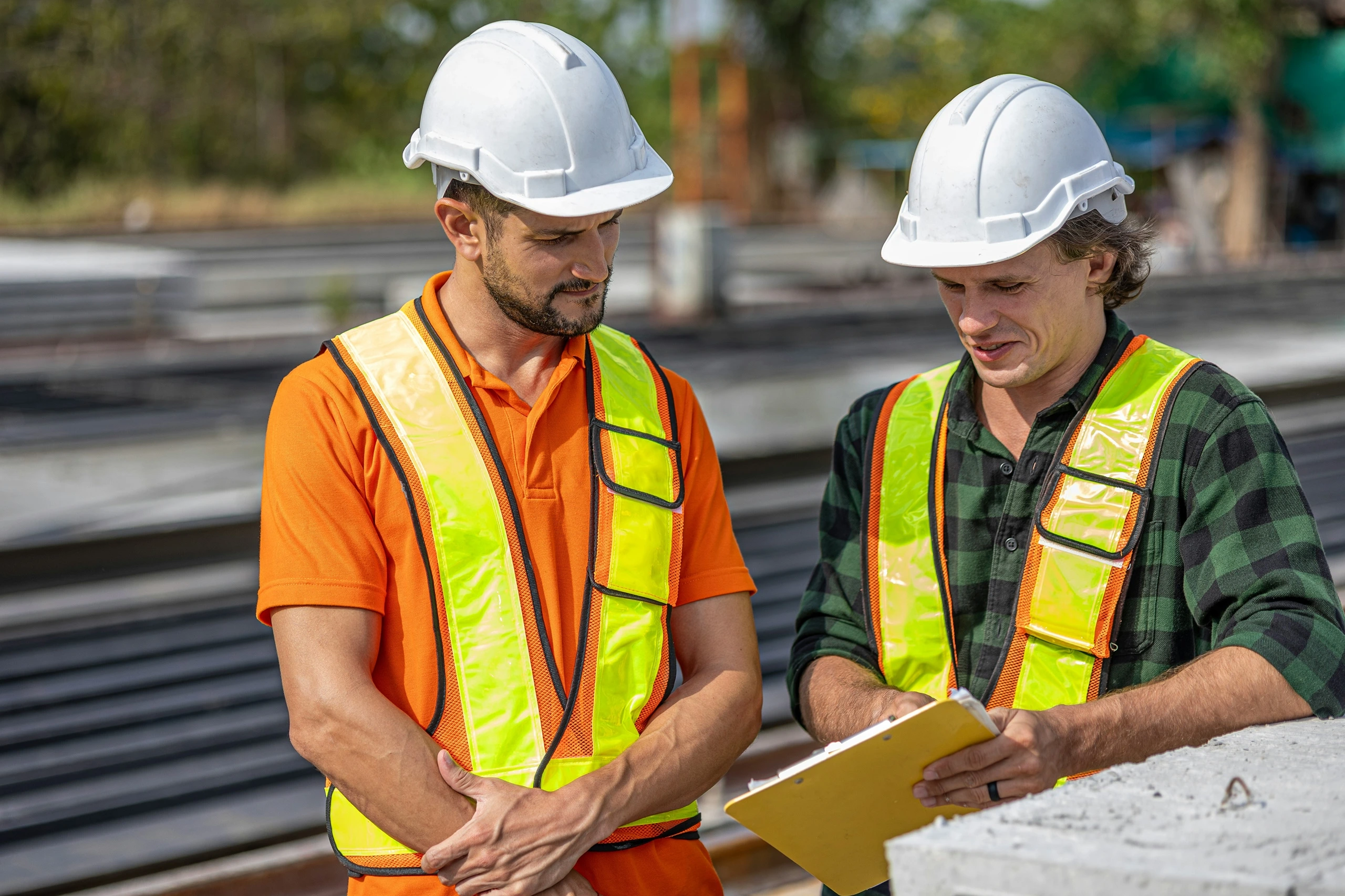 Construction supervisors reviewing site inspection checklist
